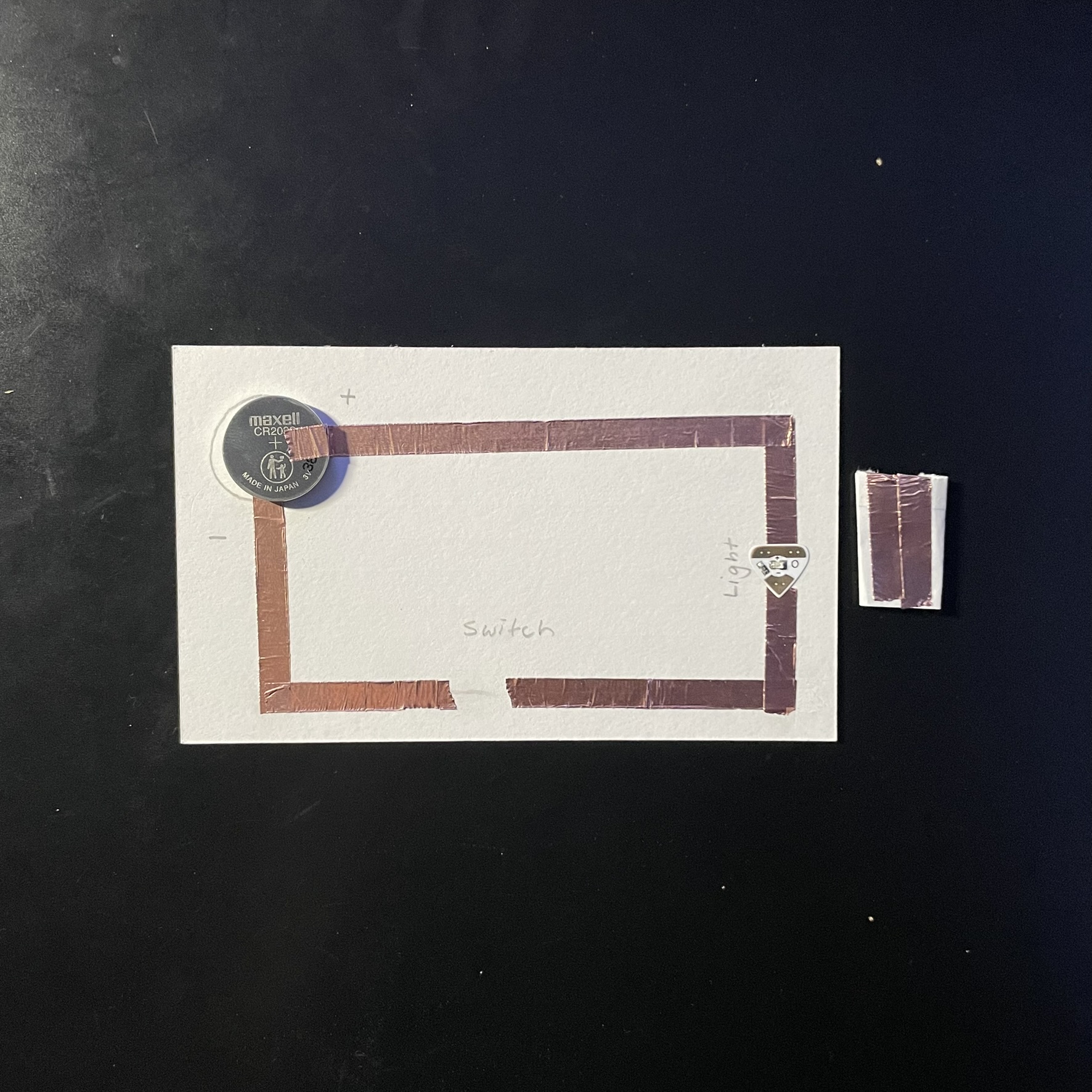 The circuit is complete here and the switch is shown on the side, it is just some more copper tape but added to a small piece of paper